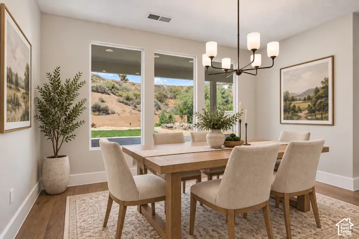 Wood-finish flooring, recessed ceiling lighting, and a contemporary chandelier