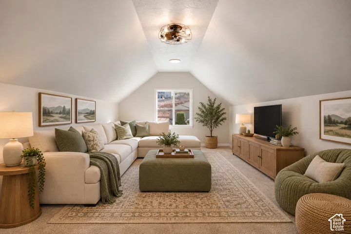 Vaulted ceiling with an overhead light fixture, carpeted flooring, and a built-in window