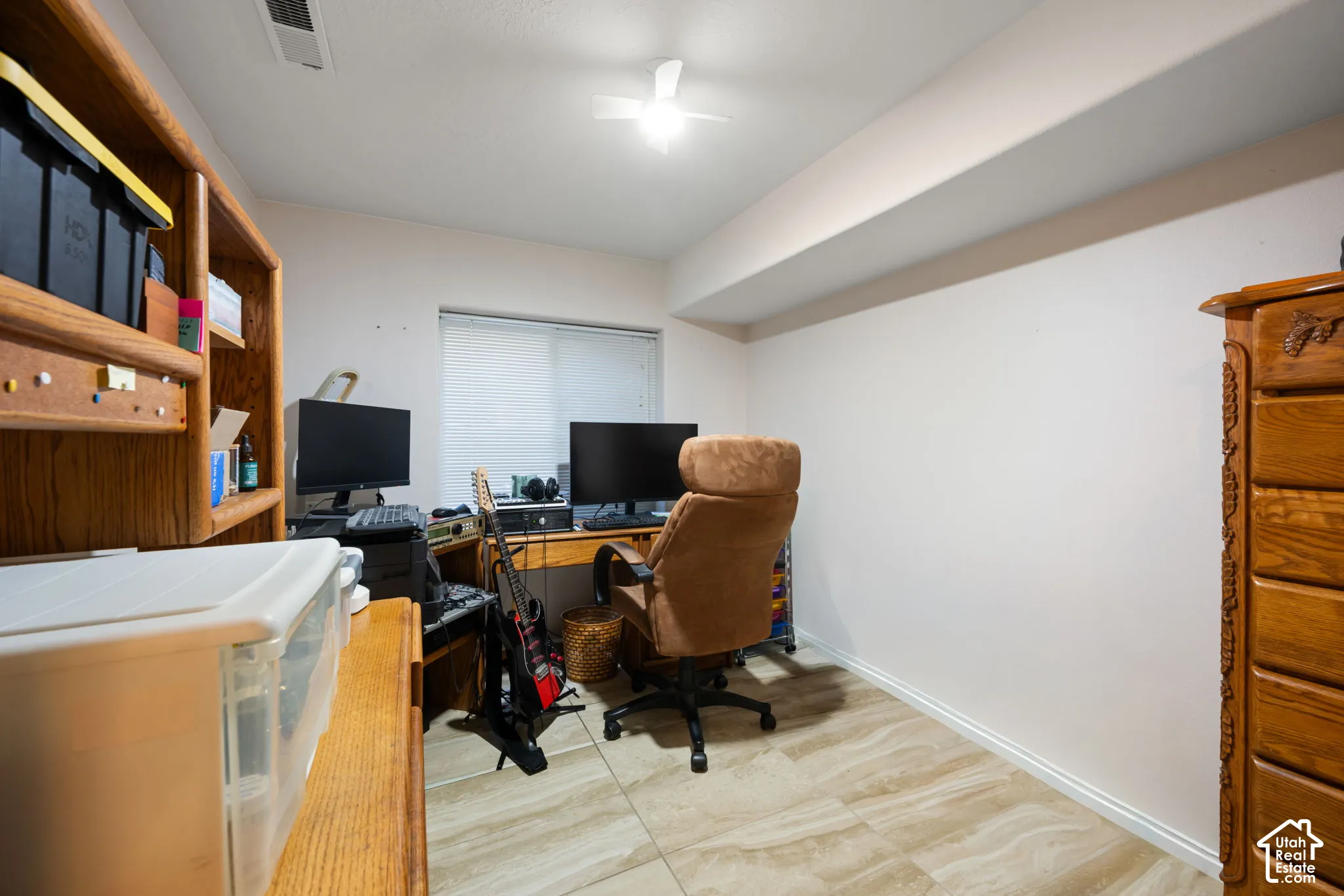Recessed window with blinds, ceiling fan, and tiled flooring