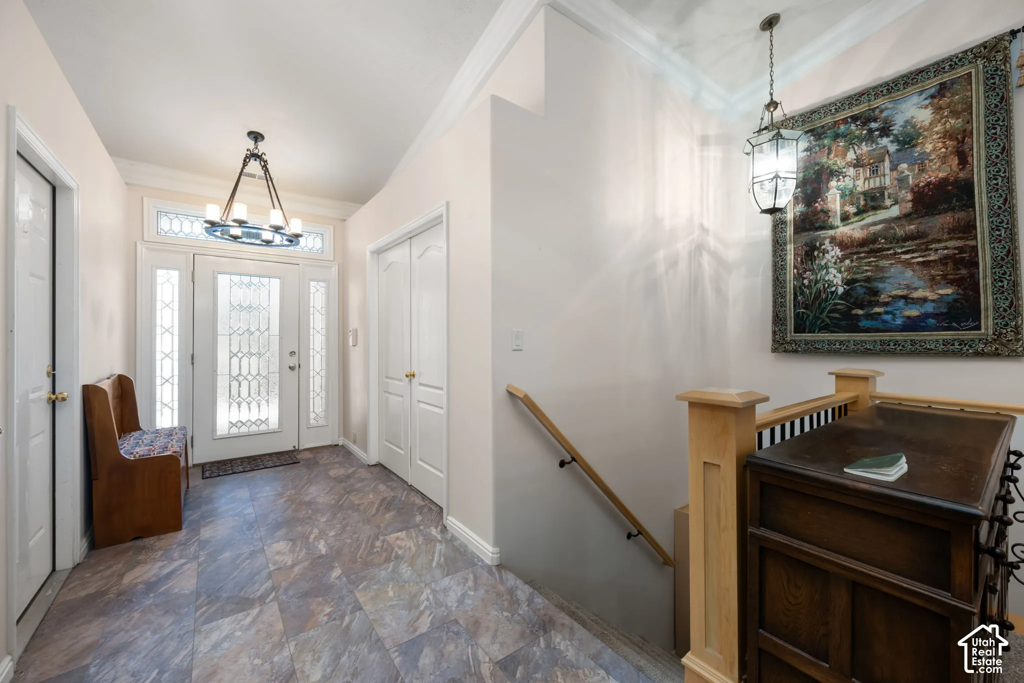 Entryway featuring a front door with decorative glass panels, sidelights, and a transom window