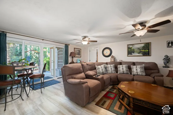 Wood-finish flooring, multiple ceiling fans, and direct patio access