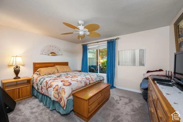 Wall-to-wall carpeting and a ceiling fan with light fixture