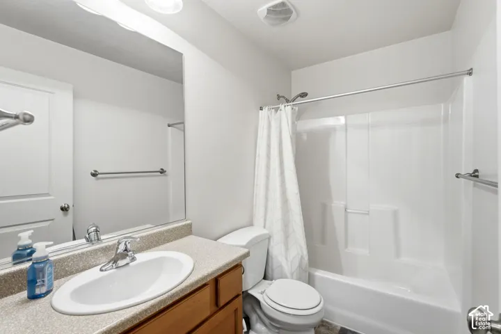 Vanity with an integrated sink, laminate countertop, and wood-finish cabinetry