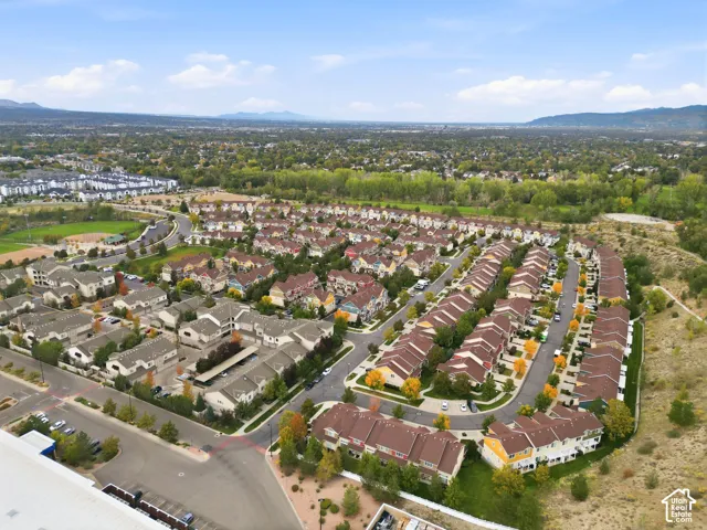 Expansive residential community featuring a variety of townhome styles, mature landscaping, and paved street access