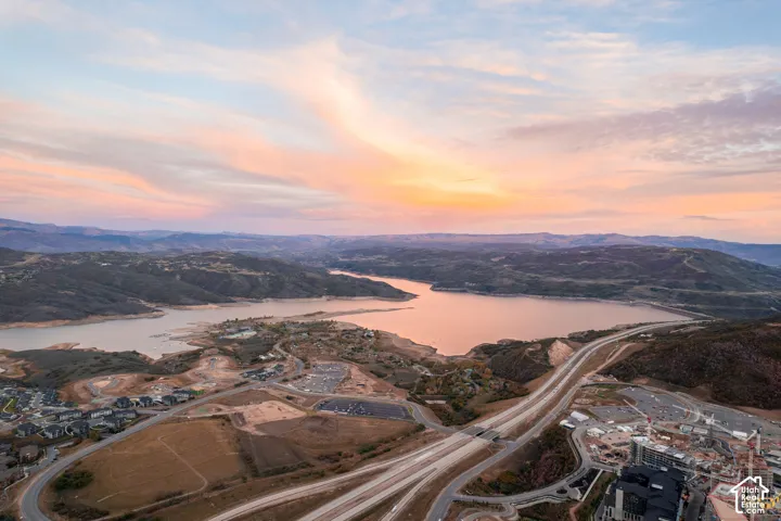 Expansive mountain and lake scenery with paved roadways and residential developments