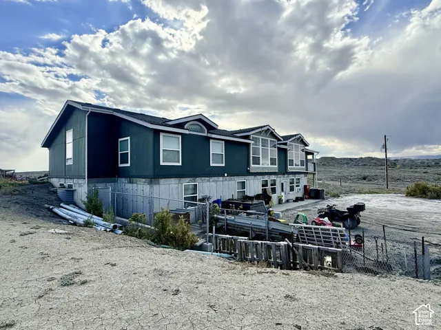 Two-story residence with a concrete foundation and dark siding