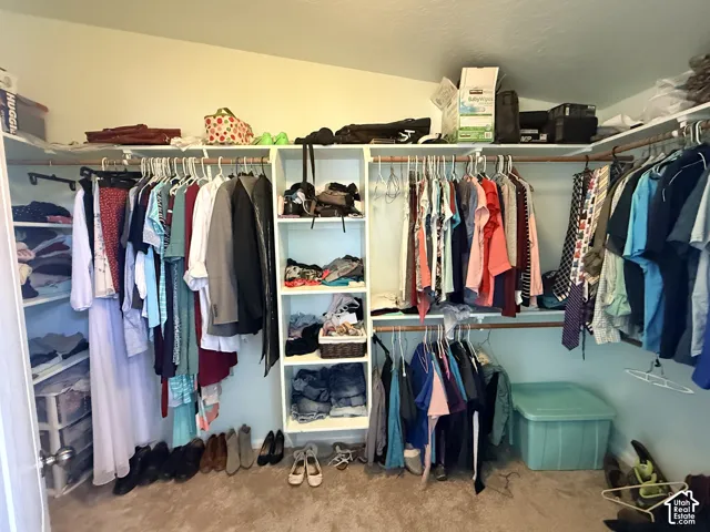 Built-in closet system featuring multiple hanging rods and integrated shelving units