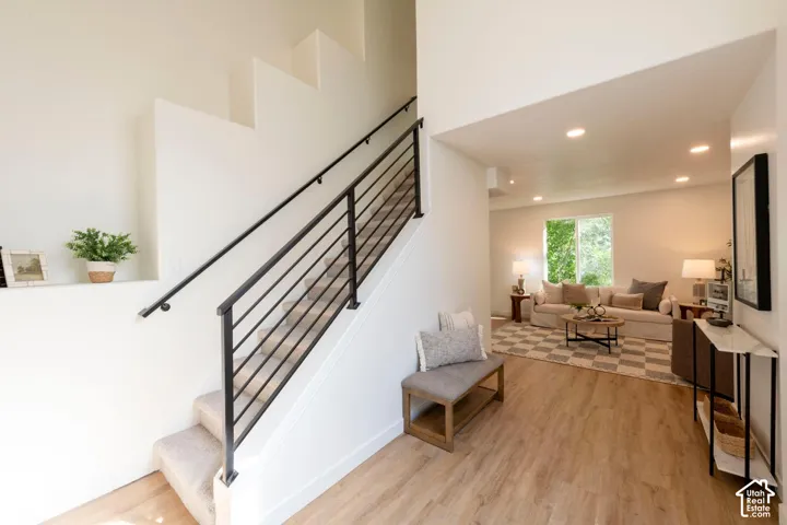 Carpeted staircase with black metal railing