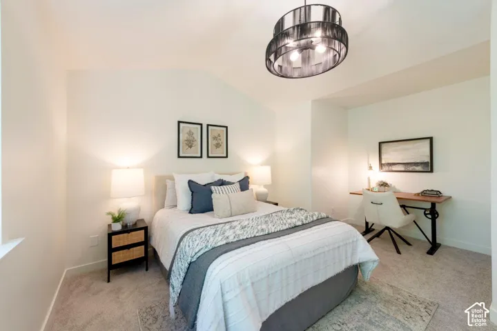 Vaulted ceiling with a contemporary drum light fixture, recessed wall niche, and carpeted flooring