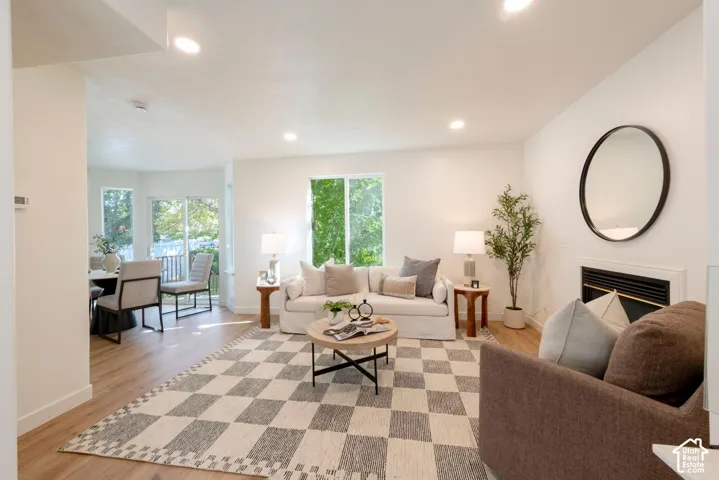 Recessed lighting throughout, wood-finish flooring, and a built-in fireplace