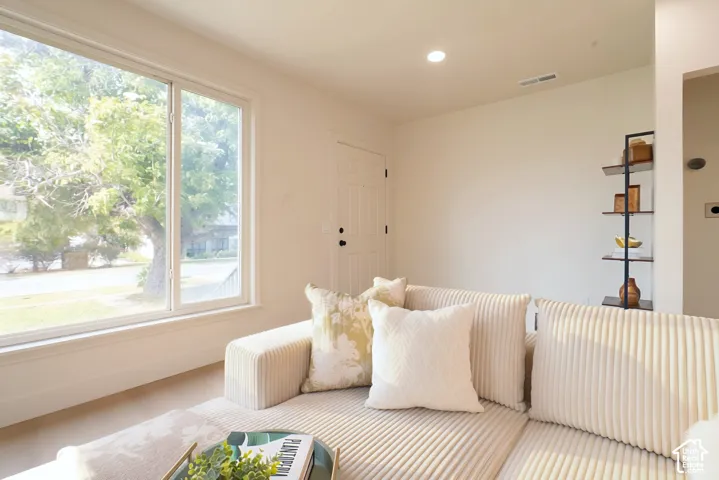 Wall-mounted shelving unit, recessed ceiling lighting, and large window