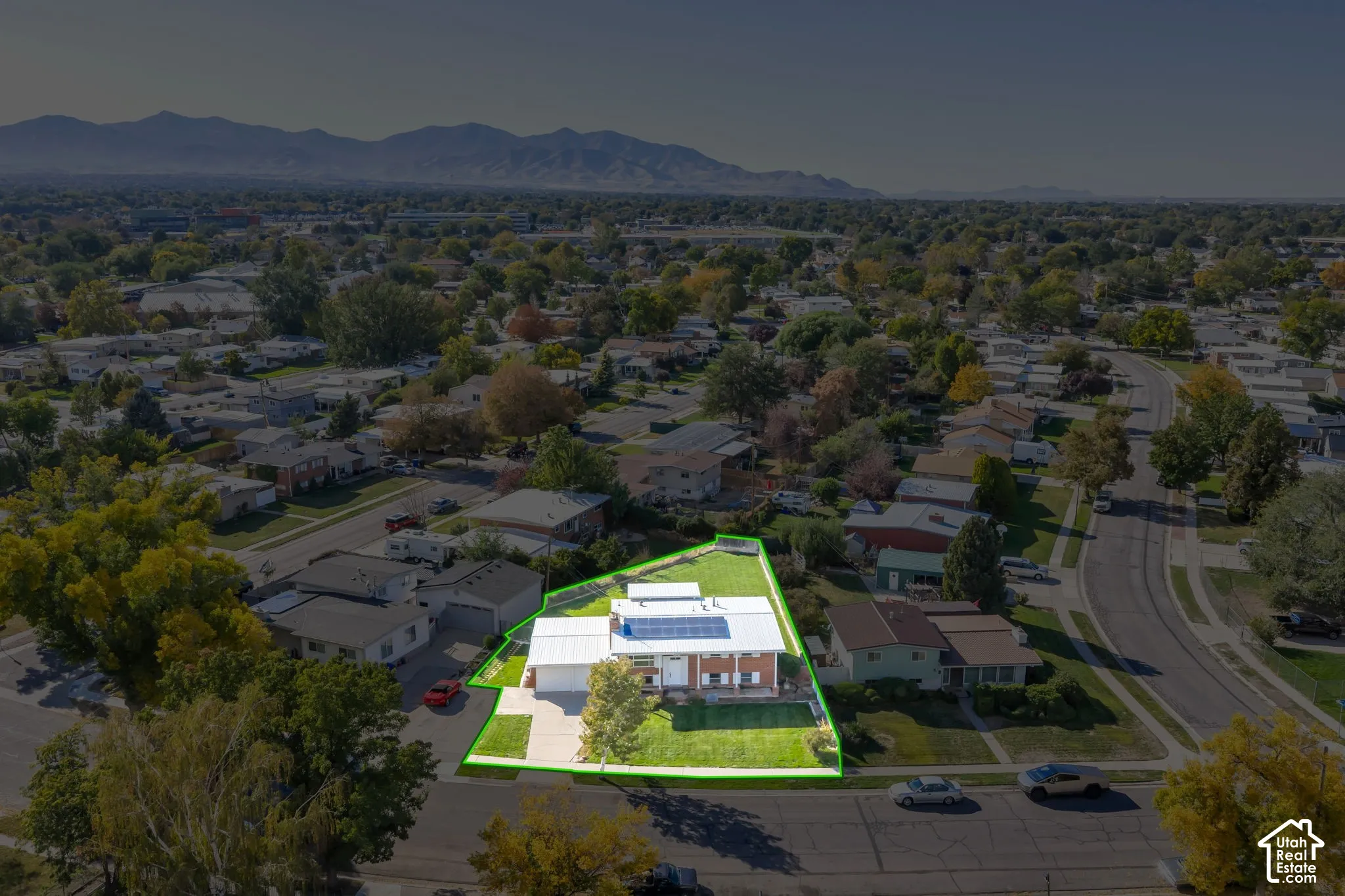 Spacious corner lot with a single-story residence, attached garage, and a manicured lawn