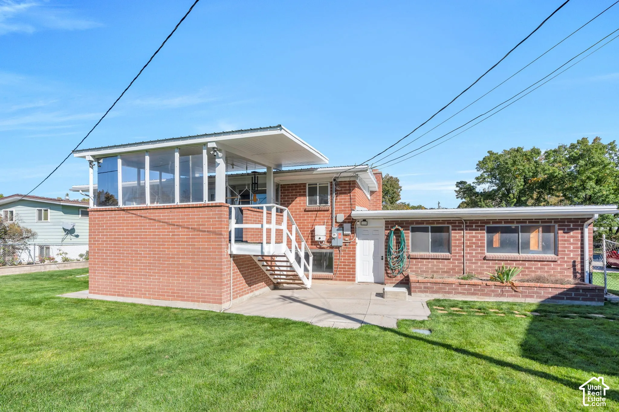 Brick exterior with an upper-level enclosed patio