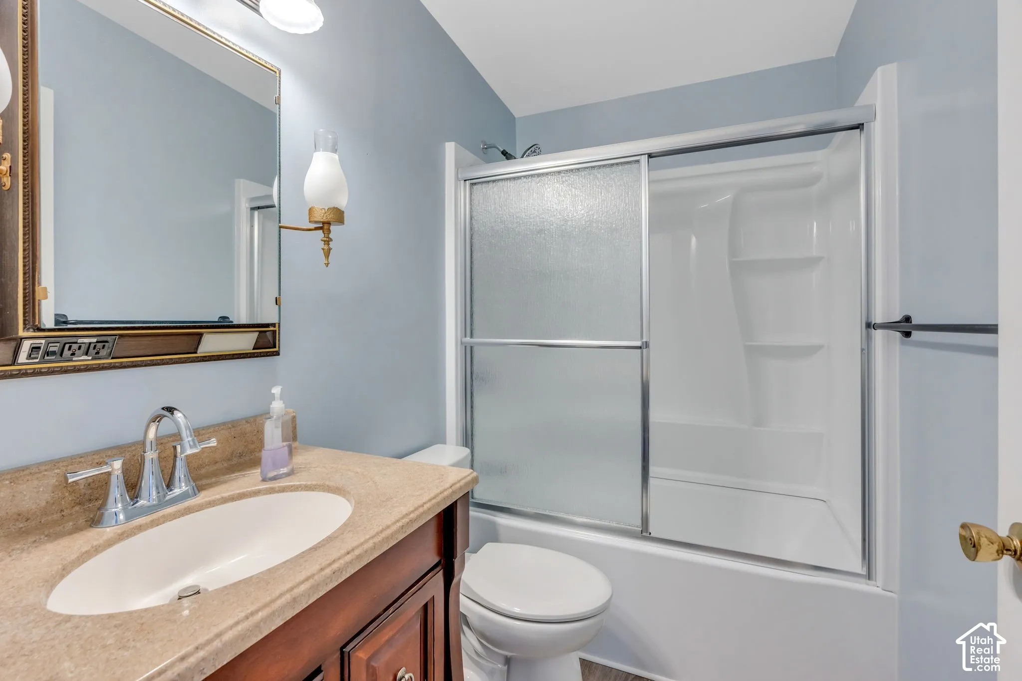Wood-finish vanity with an integrated sink and chrome faucet