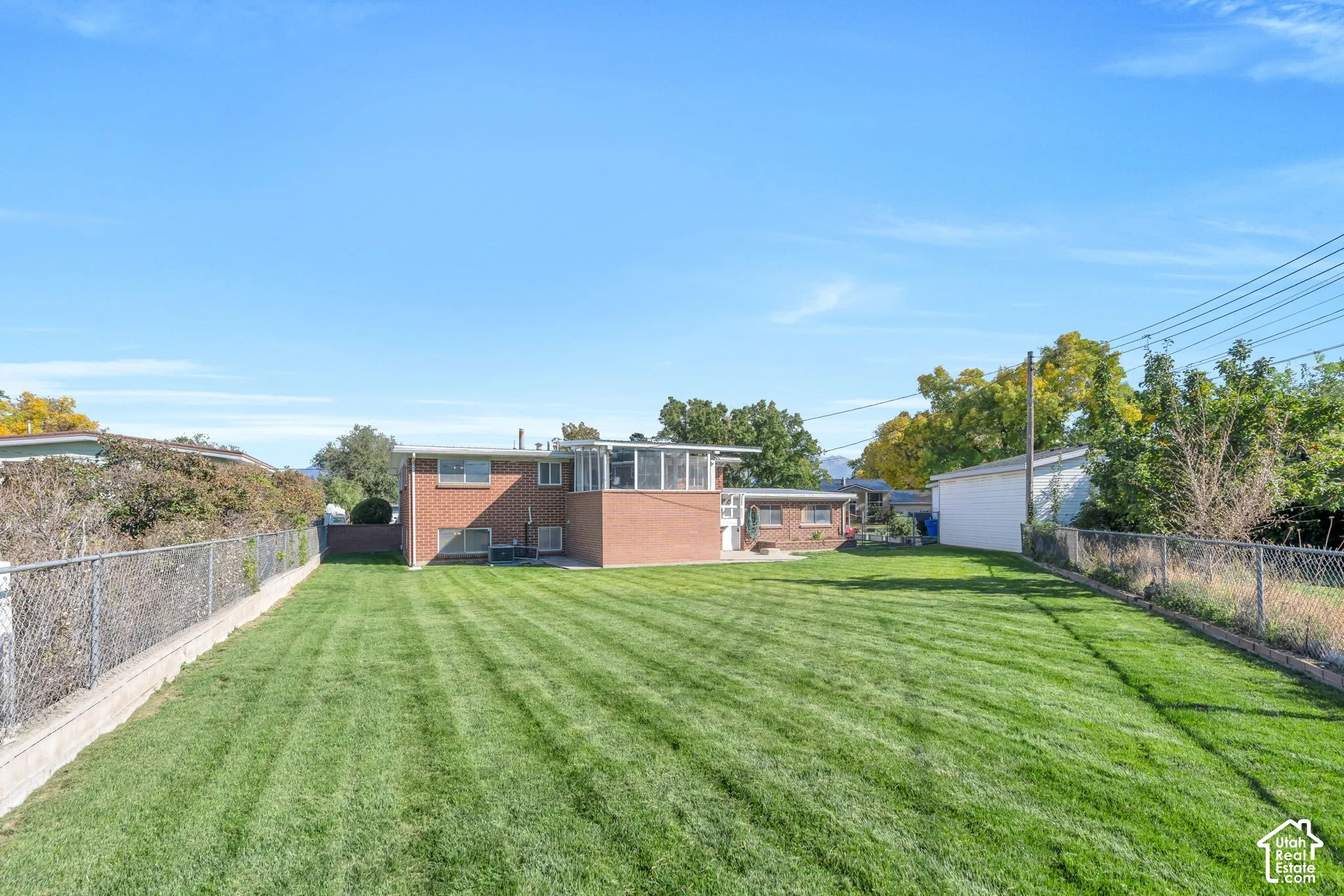 Expansive rear yard with a manicured lawn