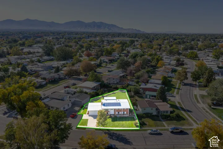 Spacious corner lot with a single-story residence, attached garage, and a manicured lawn