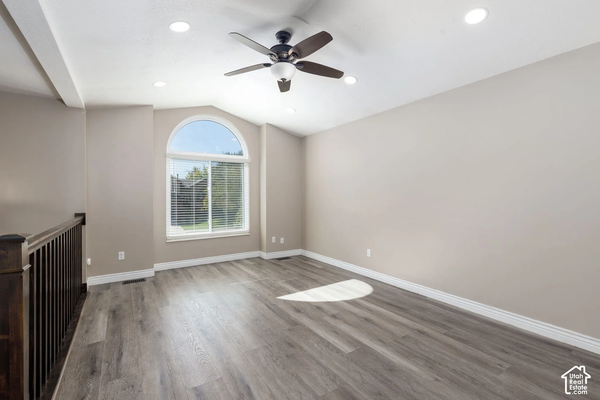 Vaulted ceiling with recessed lighting and ceiling fan