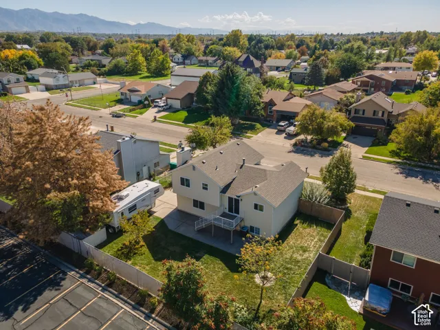 Two-story residence featuring a neutral exterior, a rear deck, and a fenced backyard