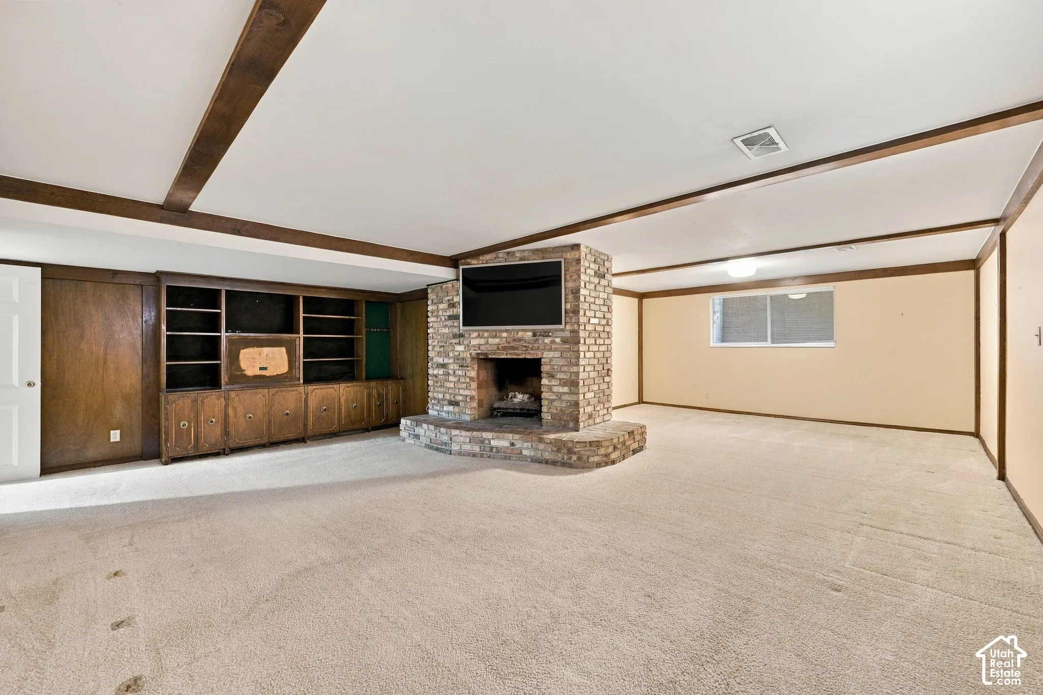 Family Room a central floor-to-ceiling brick fireplace and built-in wood cabinetry