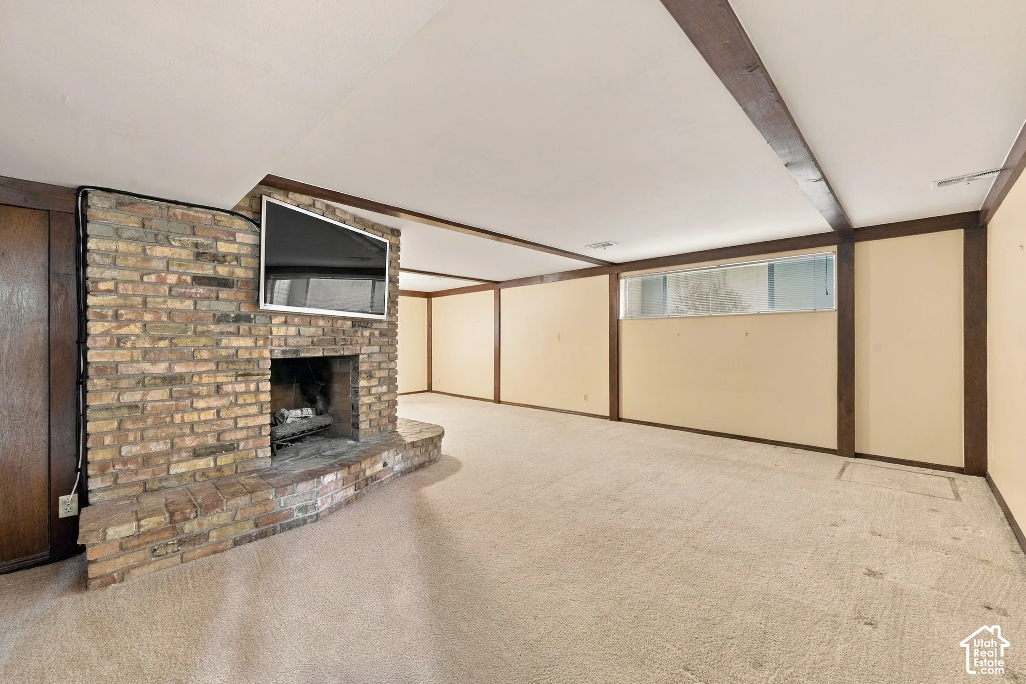 Floor-to-ceiling brick fireplace with a hearth