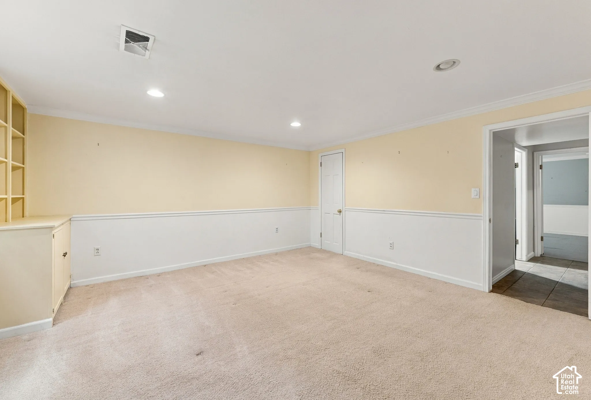Bedroom 5 featuring chair rail molding, built-in cabinetry, and recessed lighting