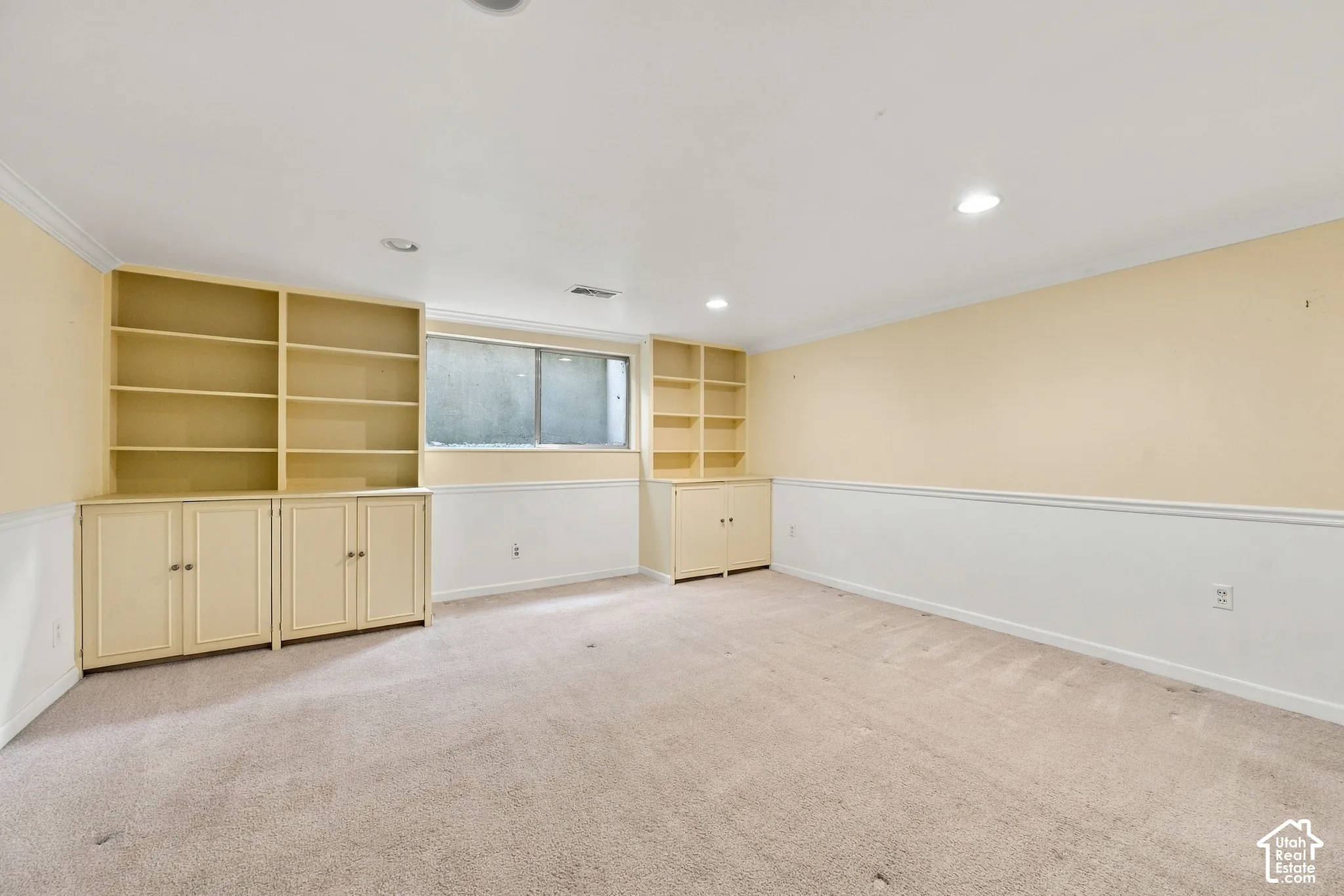 Bedroom 5 with Built-in cabinetry with integrated shelving, recessed lighting, and white chair rail molding