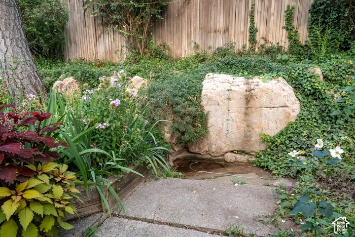 Terraced landscaping featuring natural stone accents, diverse plantings