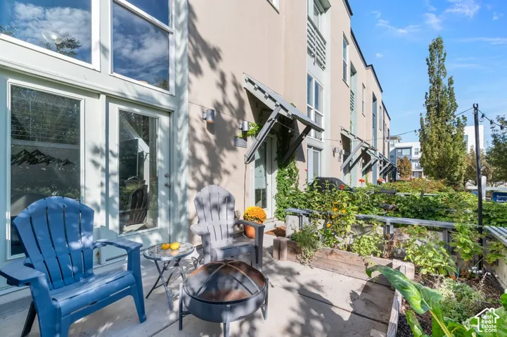 Private patio with concrete surfacing, adjacent to a wall of French doors and transom windows