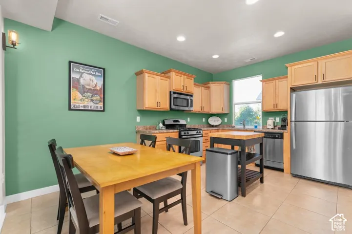 Kitchen featuring recessed lighting, a built-in microwave, stainless steel appliances, a gas range, and a window above the sink