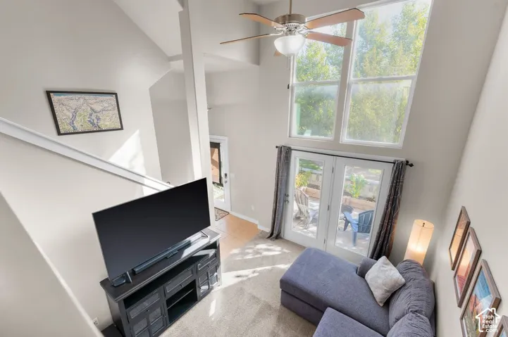 Vaulted ceilings, large transom windows, French doors, and carpeted flooring