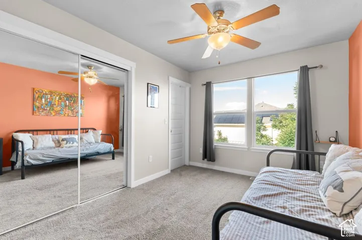 Recessed lighting, wood-finish ceiling fan, and mirrored sliding closet doors