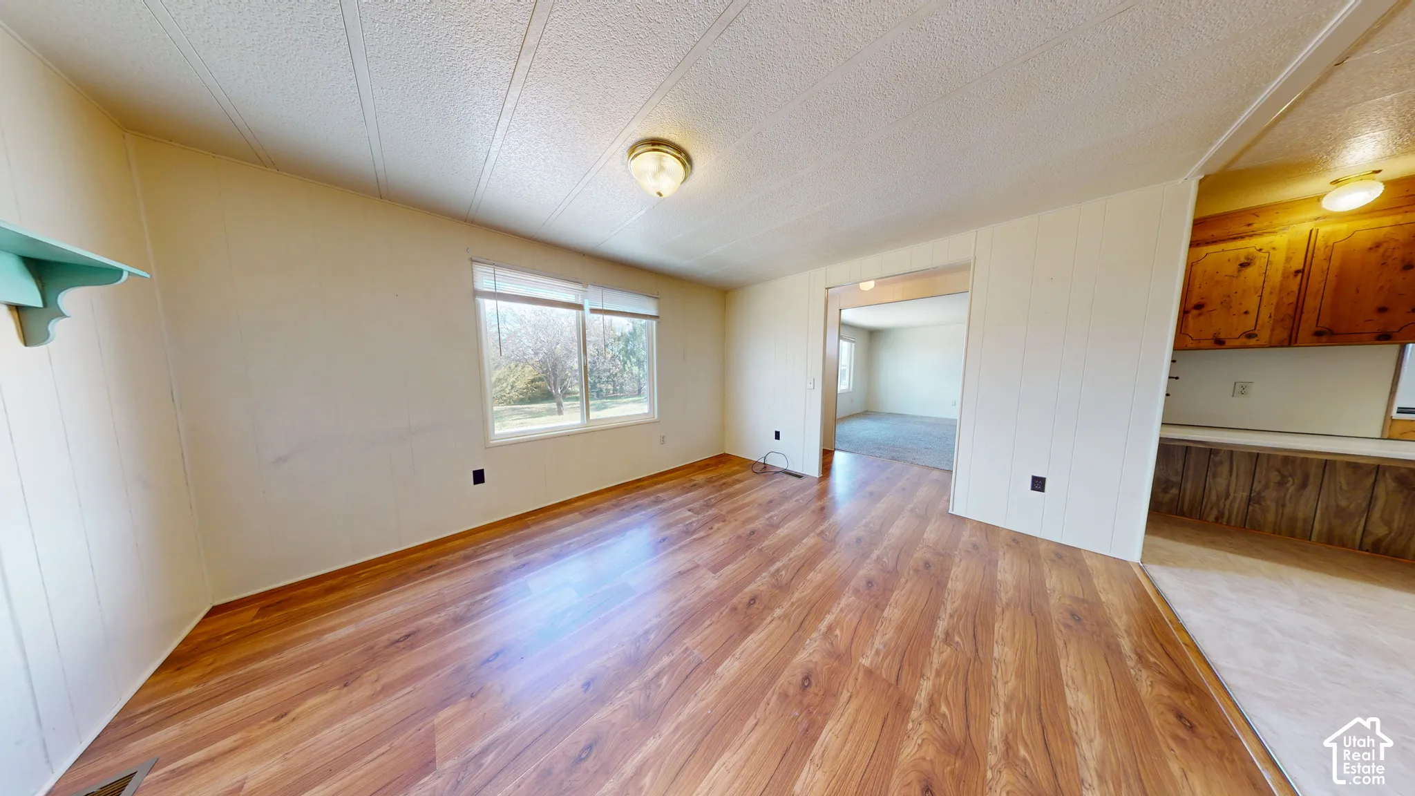 Interior space featuring wood-finish flooring, ceiling-mounted lighting, and natural light from a window