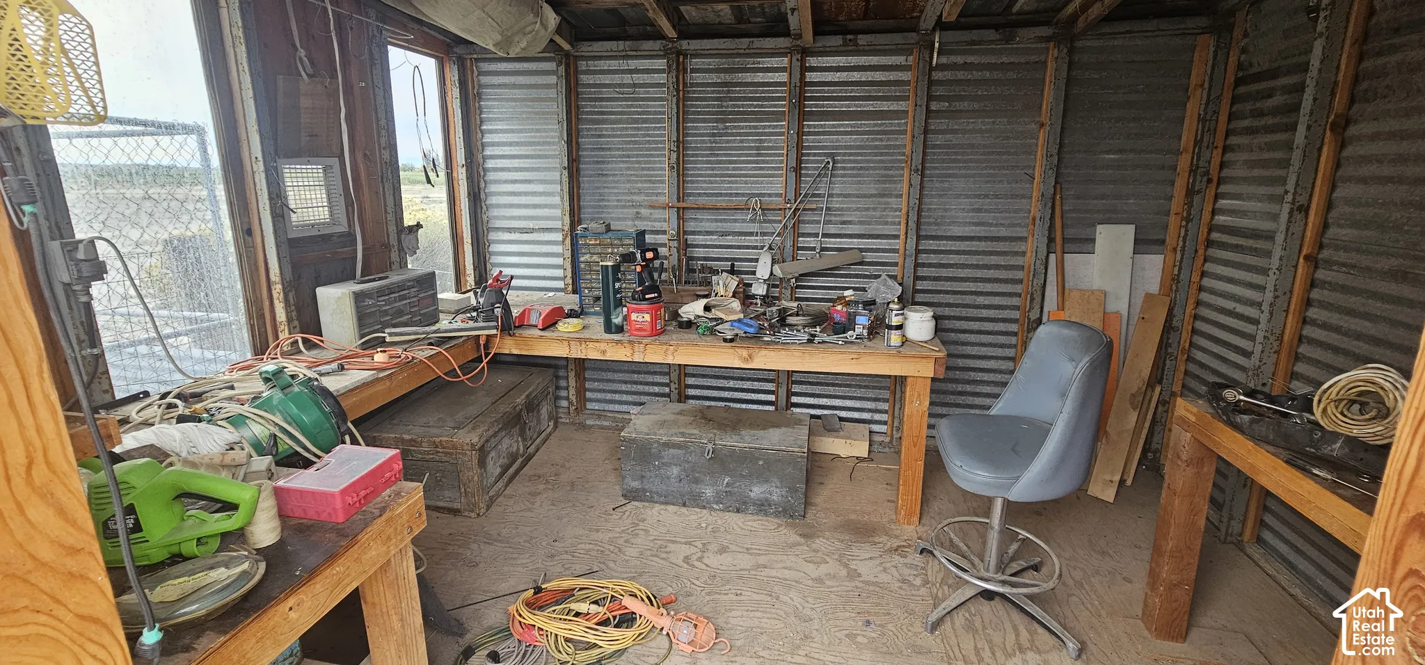 Open-frame structure with corrugated metal walls and exposed wood beams