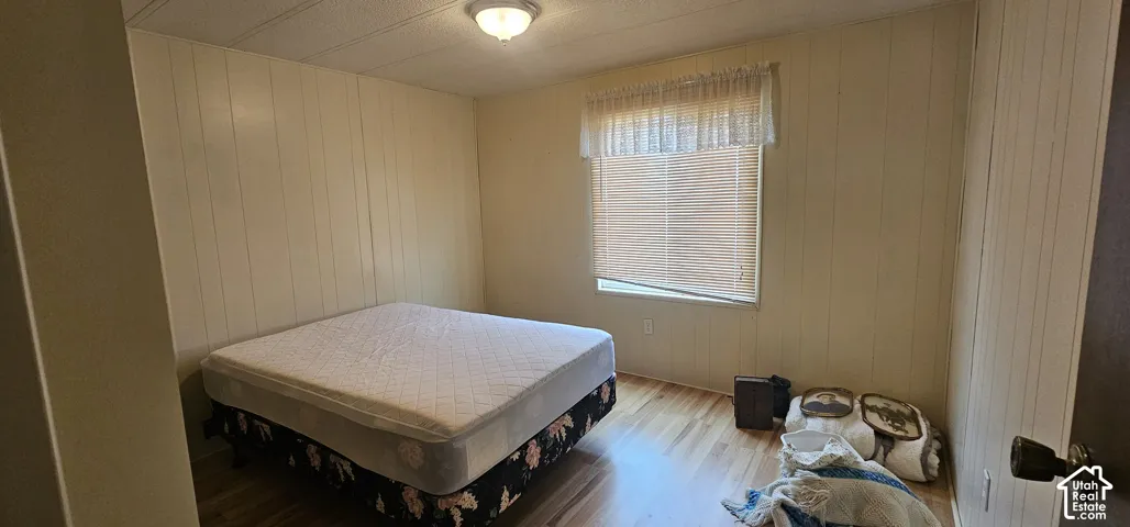 Wood-finish flooring with a window offering natural light