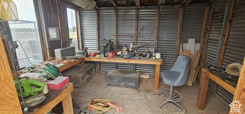 Open-frame structure with corrugated metal walls and exposed wood beams