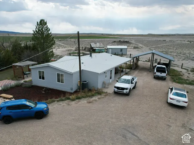Single-story residence with light gray siding and a white roof