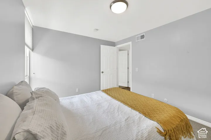 Recessed window with roller blinds, light gray wall paint, and overhead flush-mount lighting