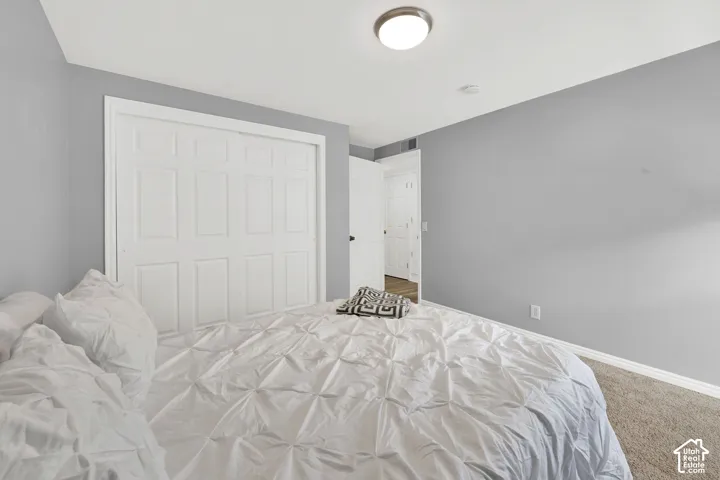 Carpeted room with a ceiling-mounted light fixture, light gray walls, and white trim
