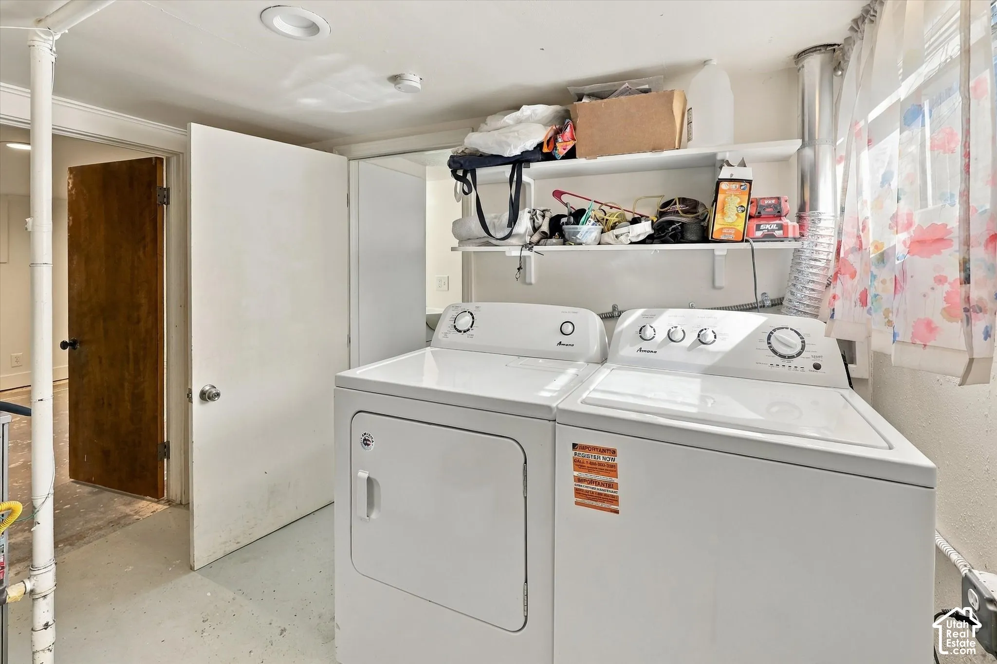 Laundry area with white walls and built-in shelving