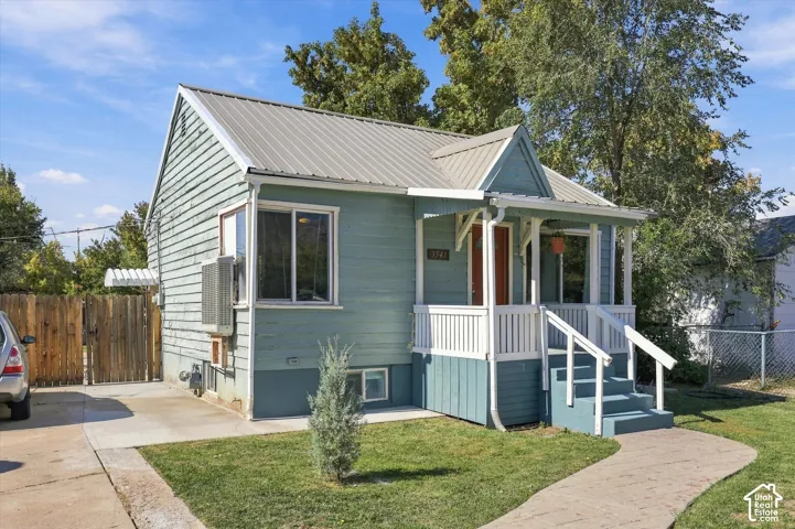 Light blue siding exterior with a metal roof