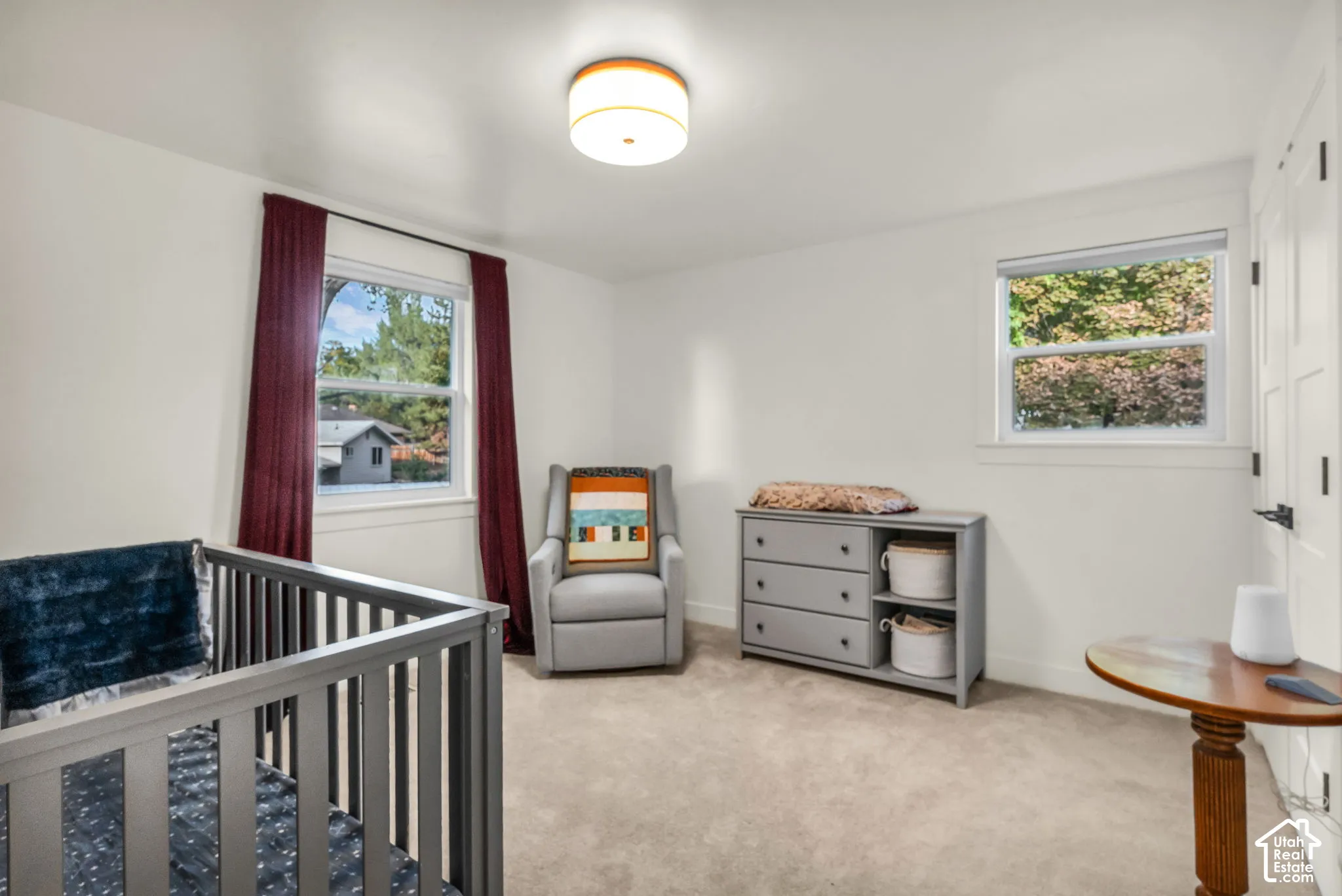 White walls, natural light, recessed lighting, carpeted flooring, and a paneled door with black hardware