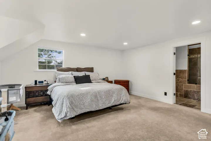 Carpeted flooring with recessed lighting, an angled ceiling, and a window with white trim
