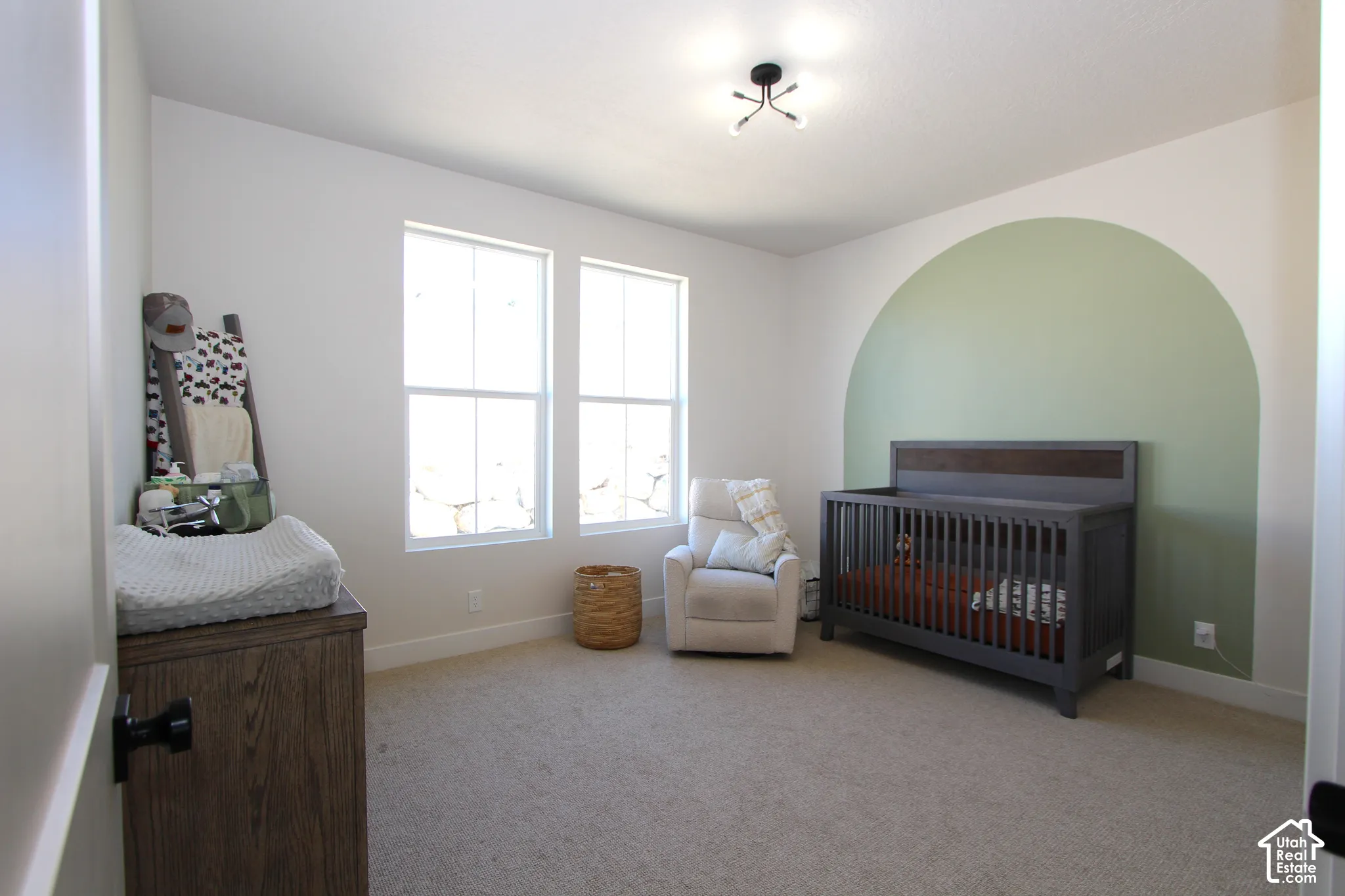 Bright room featuring two windows, recessed ceiling light, and light-toned carpeting