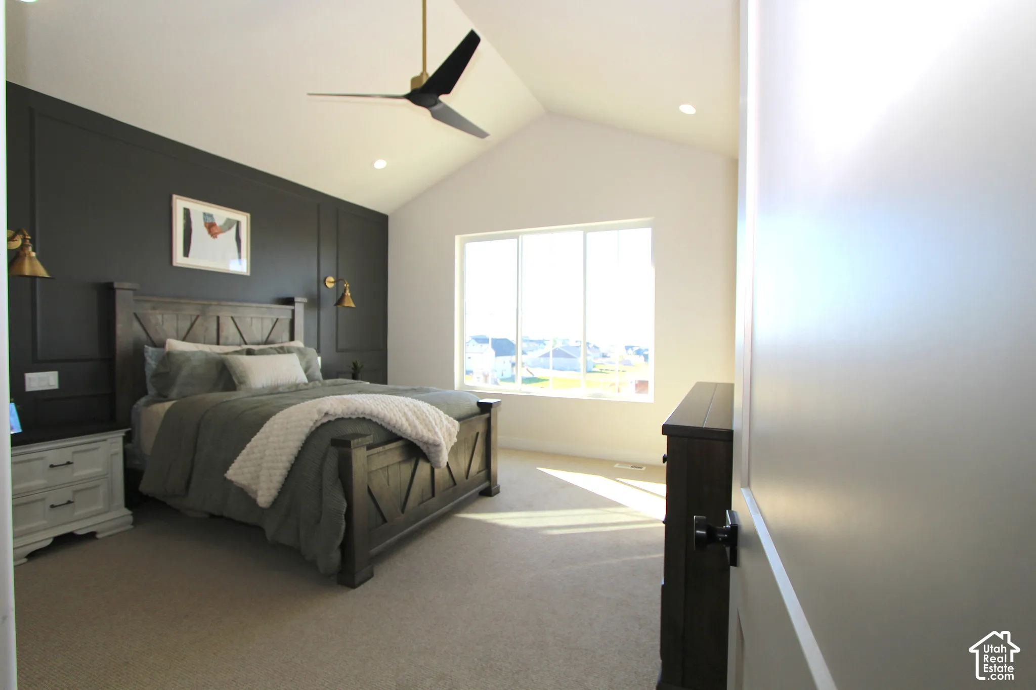 Vaulted ceiling featuring a contemporary ceiling fan, recessed lighting, and a large window