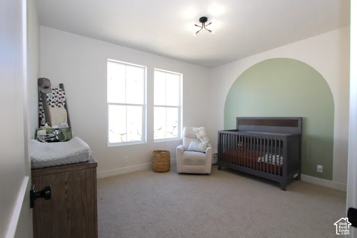 Bright room featuring two windows, recessed ceiling light, and light-toned carpeting
