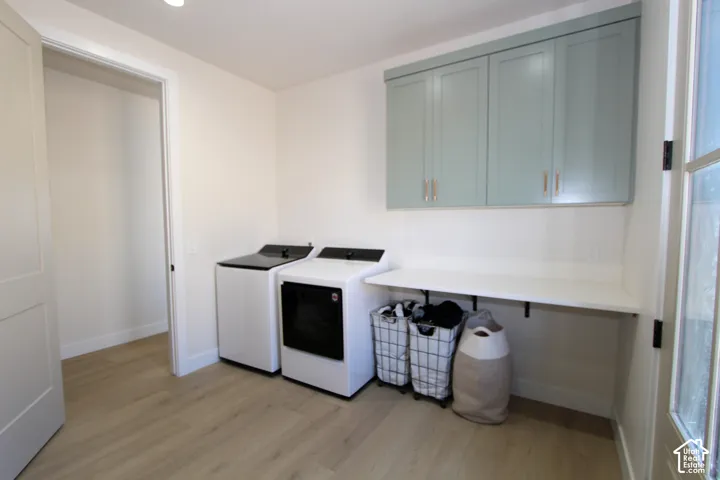 Built-in shelving with light blue cabinetry, wood-finish flooring, and a white countertop