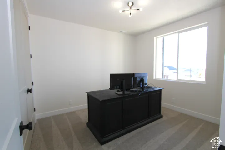 Recessed lighting fixture, light-toned carpeting, white walls, and a large window