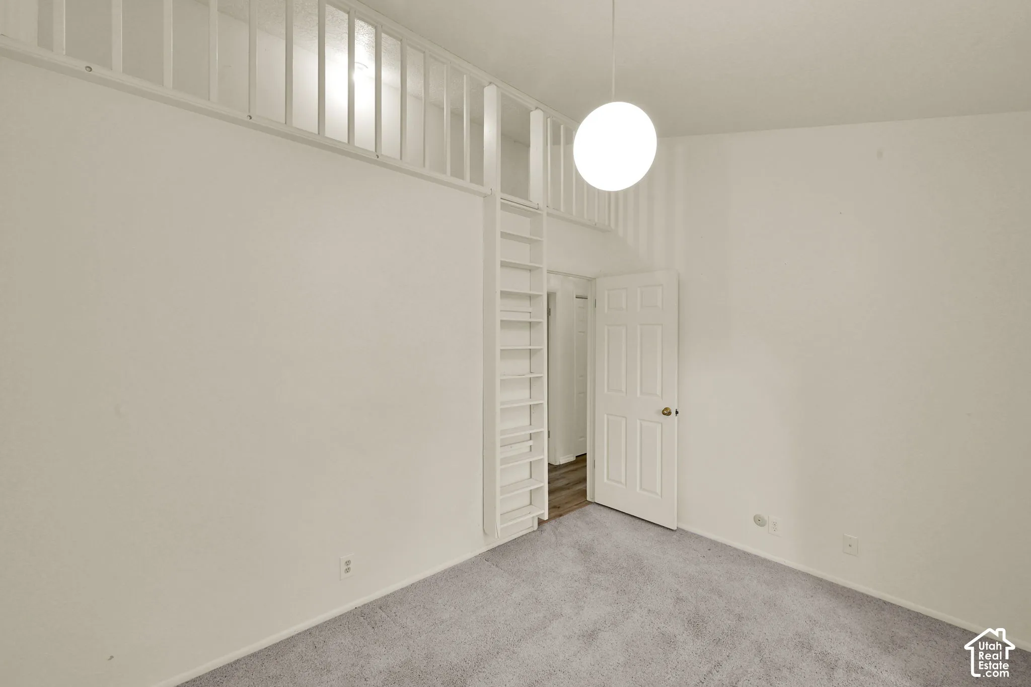 Bedroom 3. Carpeted flooring with white wall finishes and loft area
