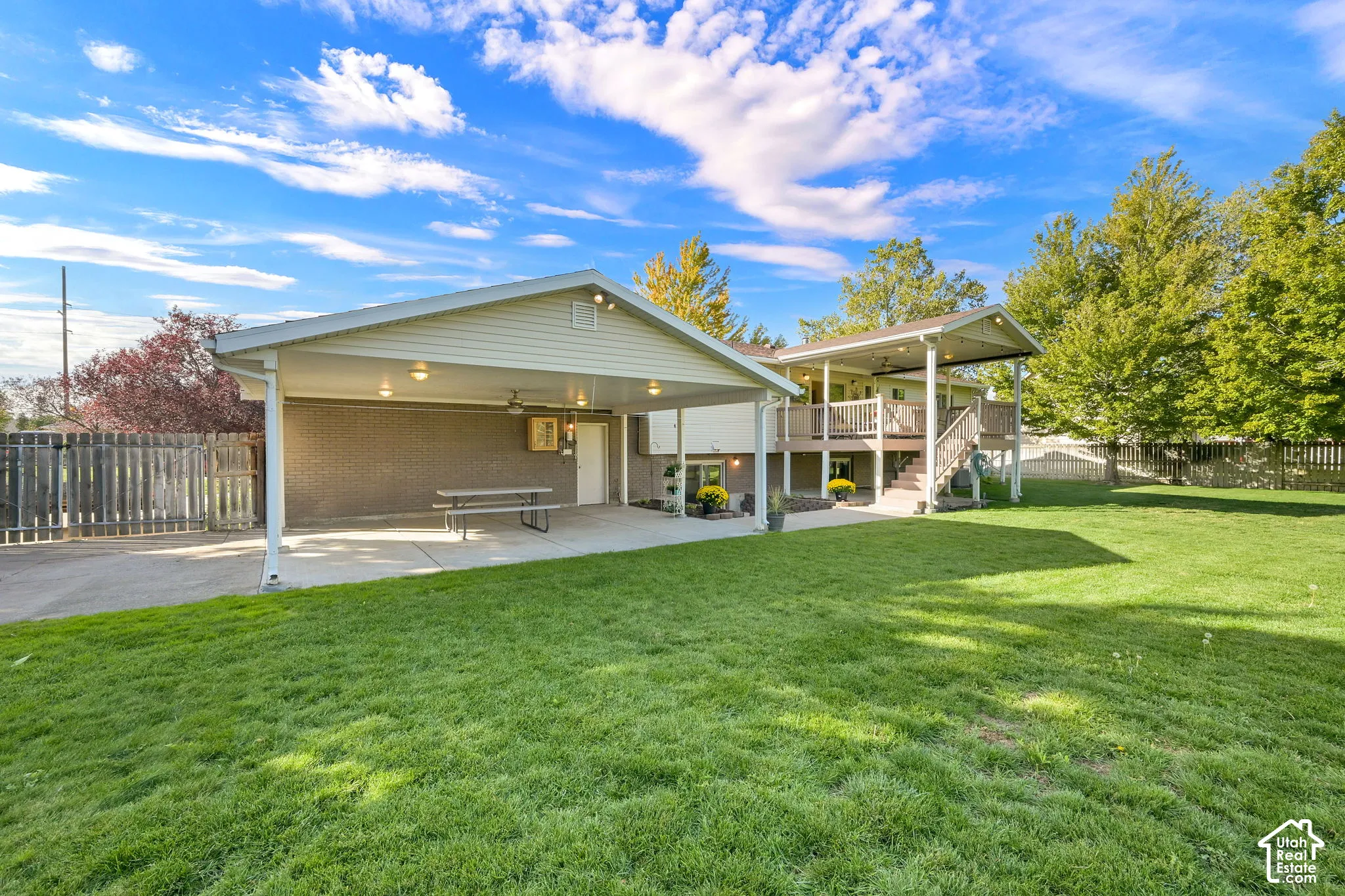 Expansive lawn with a two-story back deck and covered patio