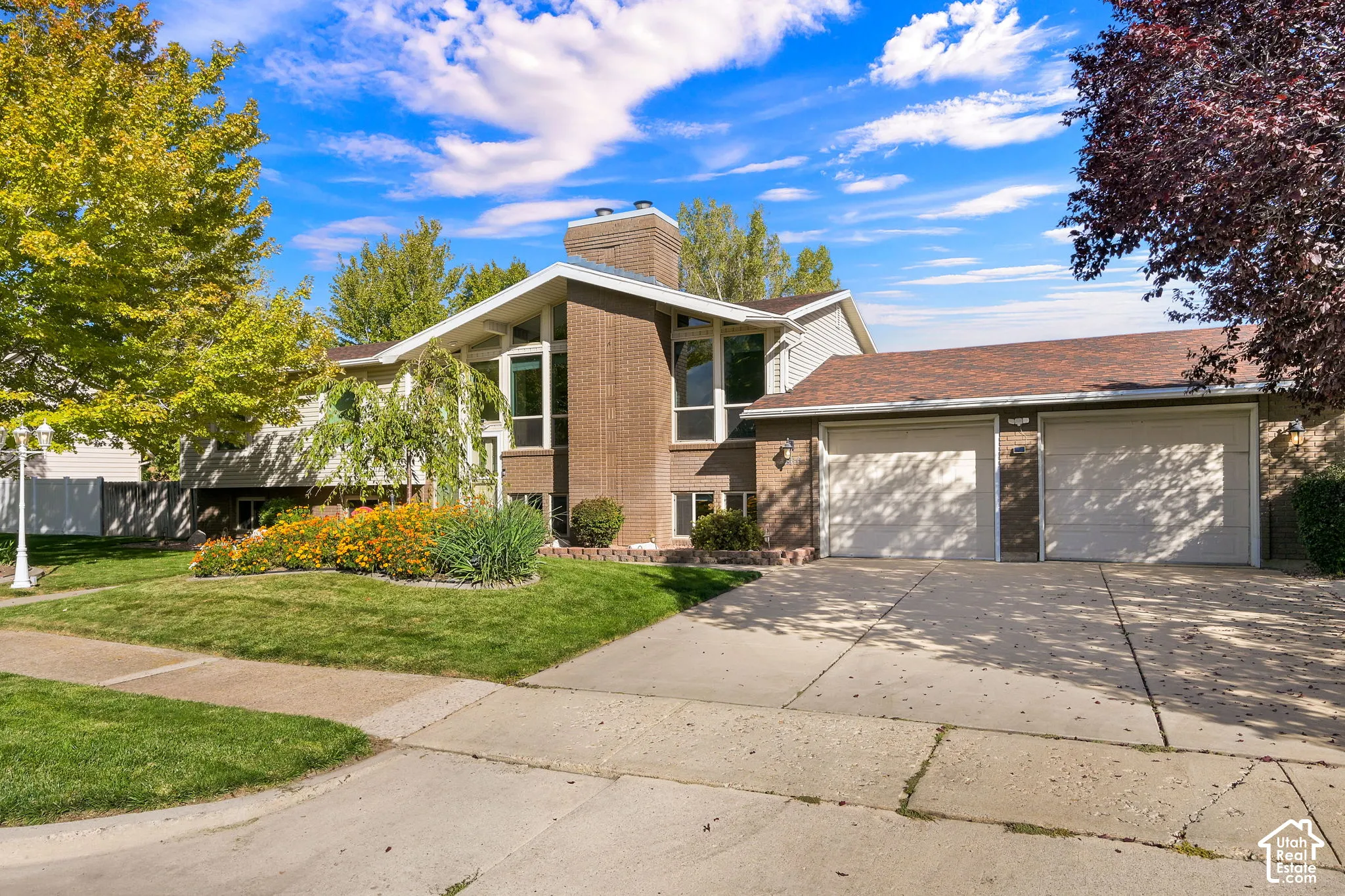 Split entry home with brick and vinyl siding, large windows